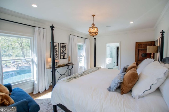 bedroom featuring wood-type flooring, an inviting chandelier, connected bathroom, and ornamental molding