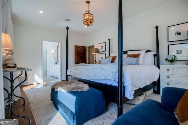 bedroom with ensuite bathroom and ornamental molding