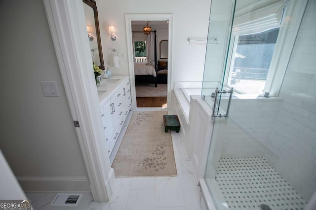 105 Fuller Dr, Carrollton, GA 30117 - full bath featuring marble finish floor, connected bathroom, a shower stall, vanity, and a tub