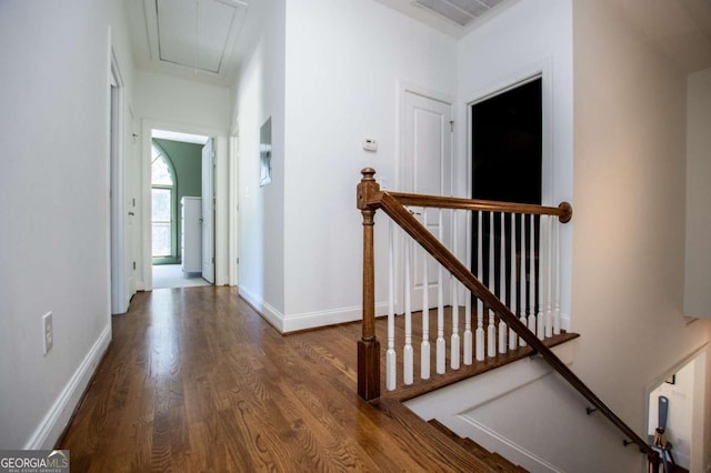 105 Fuller Dr, Carrollton, GA 30117 - hallway featuring wood finished floors, visible vents, an upstairs landing, baseboards, and attic access