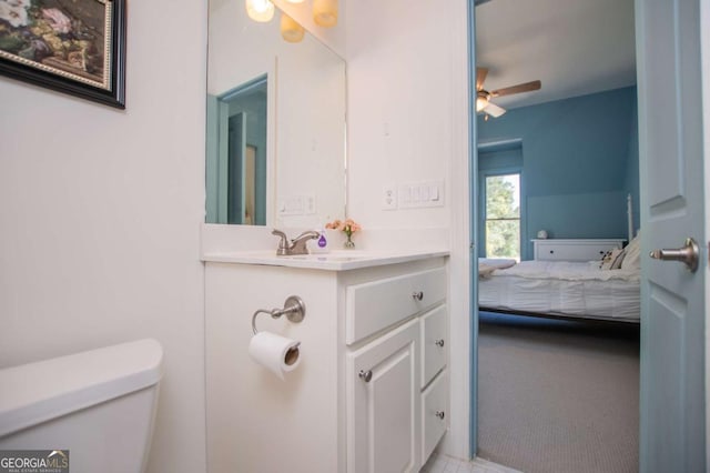 bathroom featuring vanity, ceiling fan, and toilet