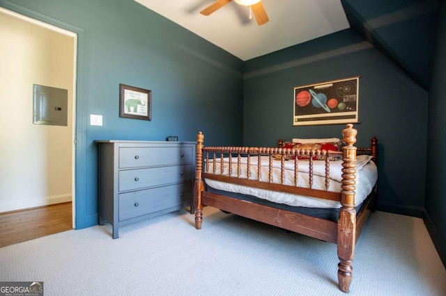 bedroom with carpet, electric panel, and ceiling fan