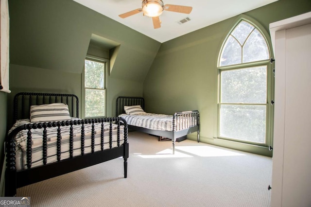 carpeted bedroom featuring ceiling fan and vaulted ceiling