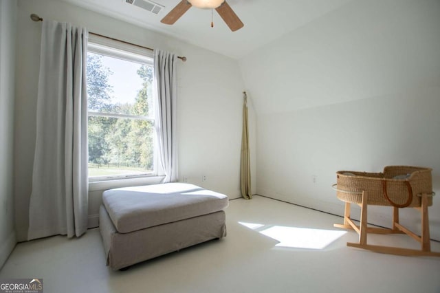 living area featuring ceiling fan and lofted ceiling