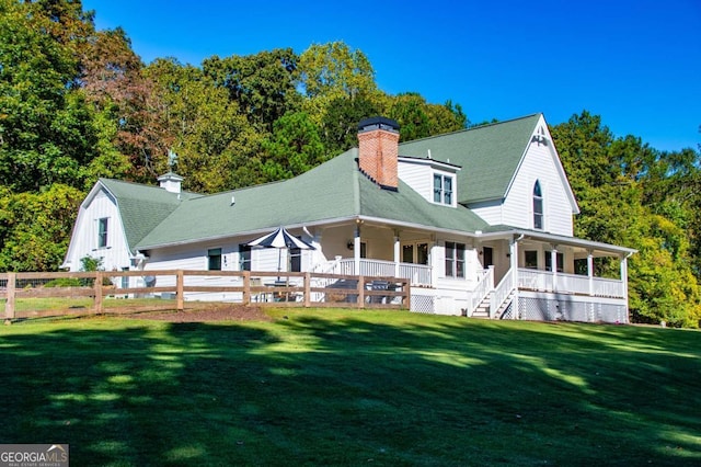 back of house with a yard and a porch