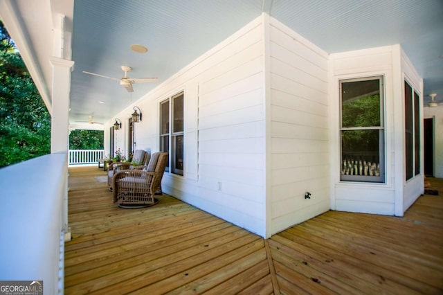 wooden terrace featuring a porch and ceiling fan