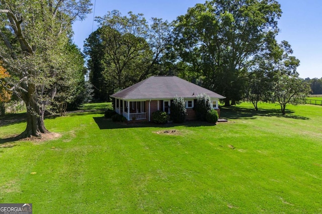 105 Fuller Dr, Carrollton, GA 30117 - view of front of house featuring a porch, a front lawn, and brick siding