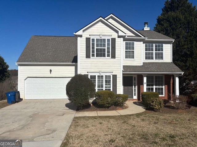 front of property featuring a garage and a front lawn