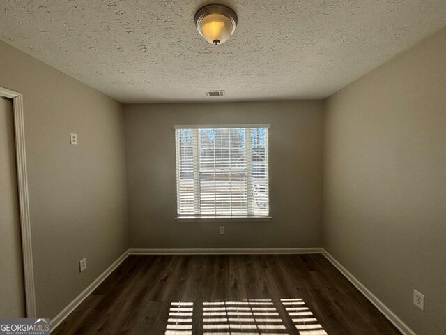 full bathroom featuring a textured ceiling, tub / shower combination, toilet, and vanity