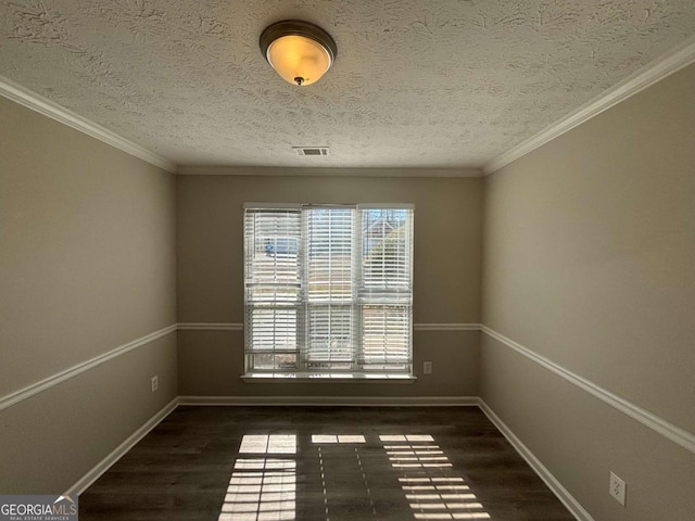 spare room with dark wood-type flooring and a textured ceiling