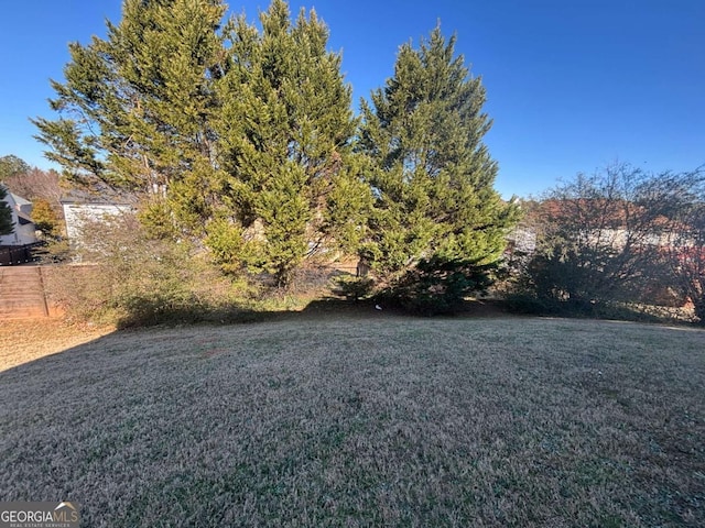 back of property featuring central AC unit and a lawn