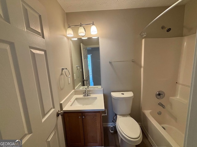 full bathroom featuring vanity, a textured ceiling, tub / shower combination, and toilet