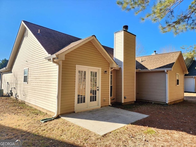 rear view of property with central air condition unit and a patio