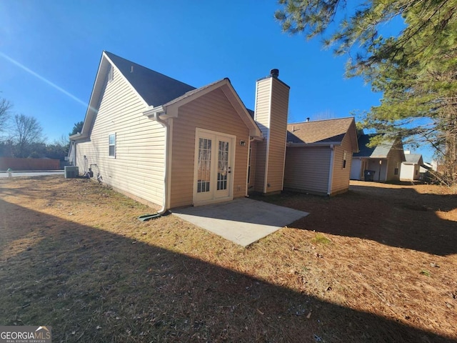 back of house with a patio area, central AC unit, and french doors