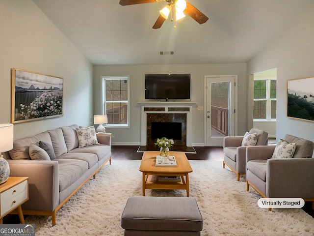 living room featuring lofted ceiling, wood-type flooring, and ceiling fan