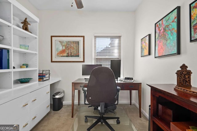 carpeted office space with ceiling fan