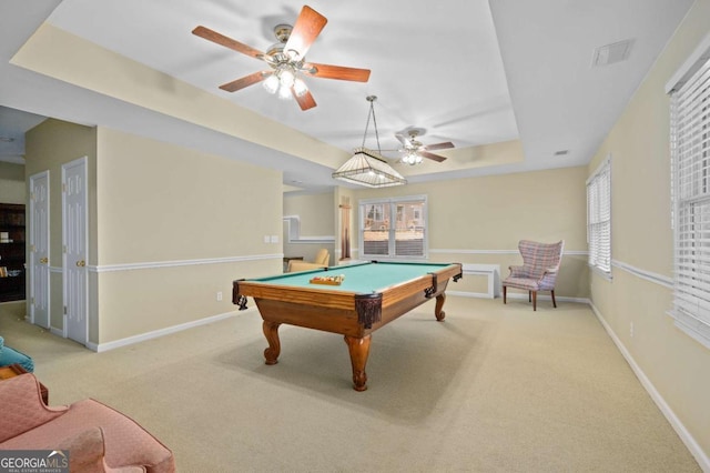 game room featuring billiards, a raised ceiling, and light colored carpet