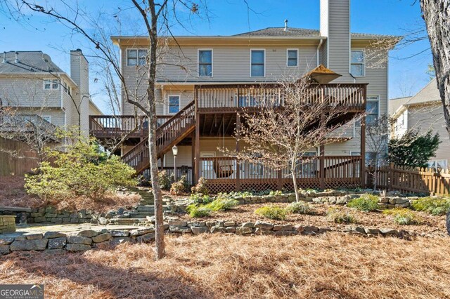 back of house featuring a wooden deck