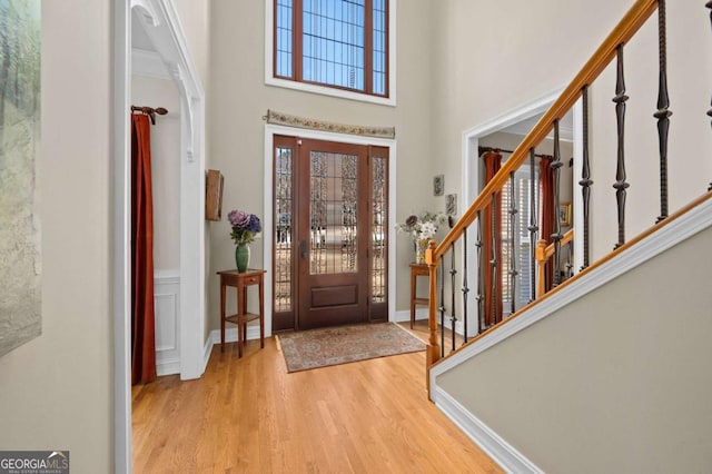 entrance foyer with light hardwood / wood-style floors and a high ceiling