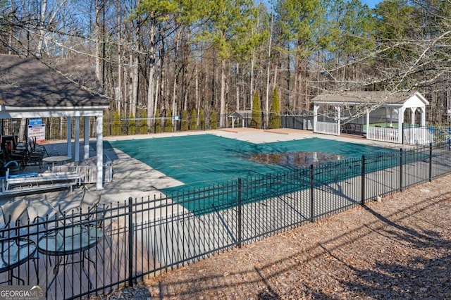 view of swimming pool featuring a patio and a gazebo