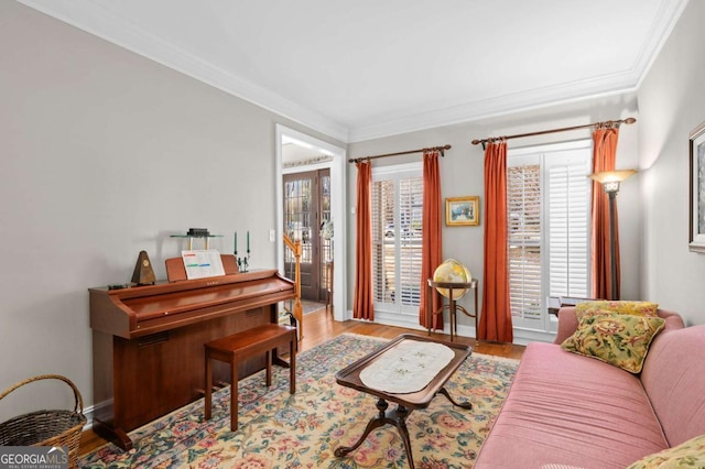 sitting room featuring light hardwood / wood-style flooring and crown molding