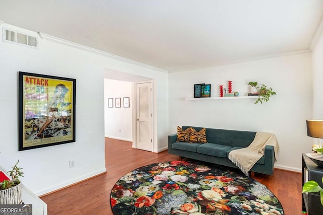 living room with hardwood / wood-style floors and ornamental molding