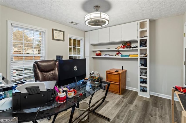 office featuring dark hardwood / wood-style floors and a textured ceiling