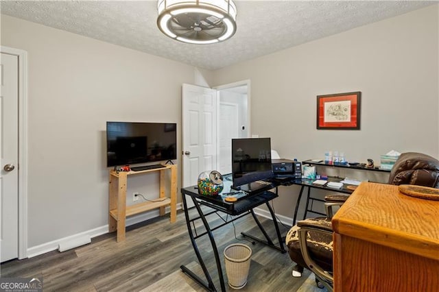 office space with wood-type flooring and a textured ceiling