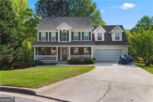 colonial inspired home with a garage, a front lawn, and a porch