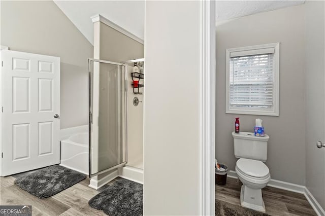 bathroom featuring toilet, lofted ceiling, wood-type flooring, and shower with separate bathtub