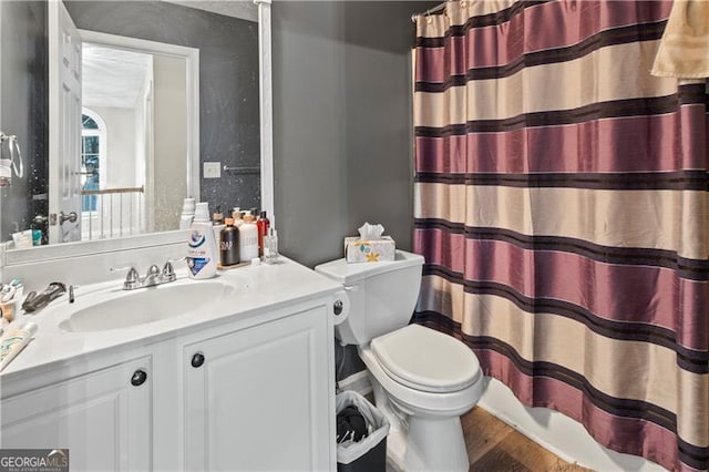 bathroom with hardwood / wood-style flooring, vanity, toilet, and a shower with curtain