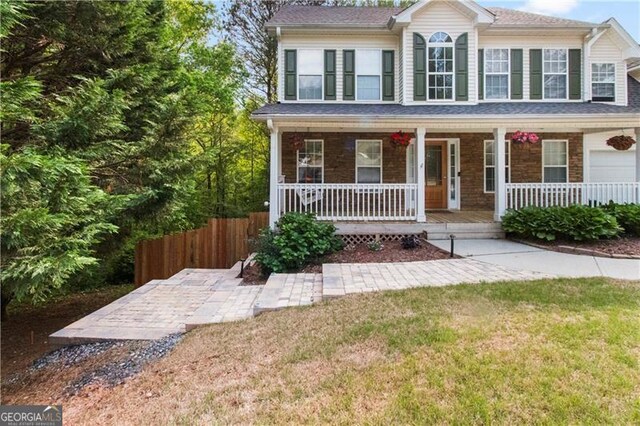 view of front of property with a porch and a front yard