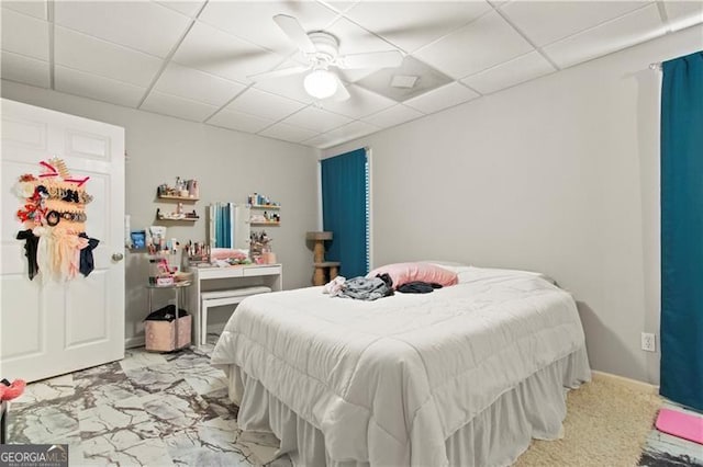 bedroom featuring ceiling fan and a drop ceiling