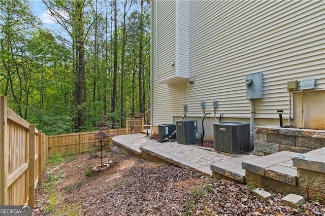 view of yard with central AC unit and a patio