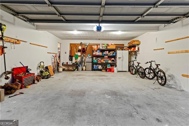 garage featuring a garage door opener and white refrigerator with ice dispenser