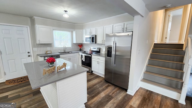 kitchen featuring a kitchen island, appliances with stainless steel finishes, and white cabinets