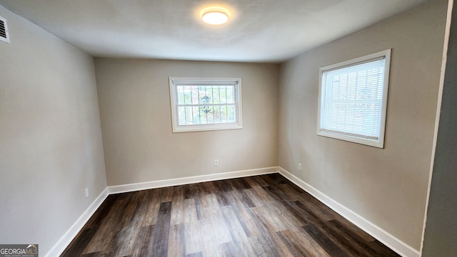 empty room with dark wood-type flooring