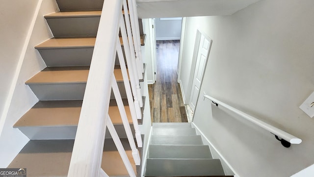 staircase featuring wood-type flooring