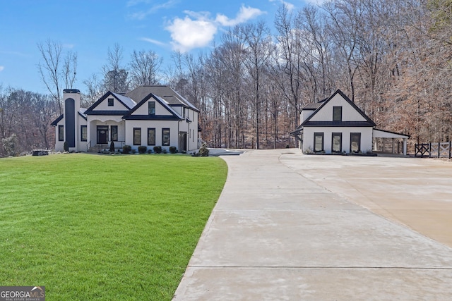 exterior space featuring a front lawn and a carport