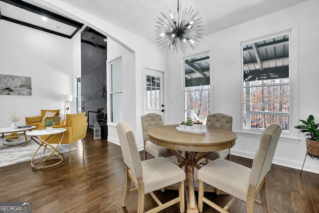 dining room with dark wood-type flooring and a chandelier