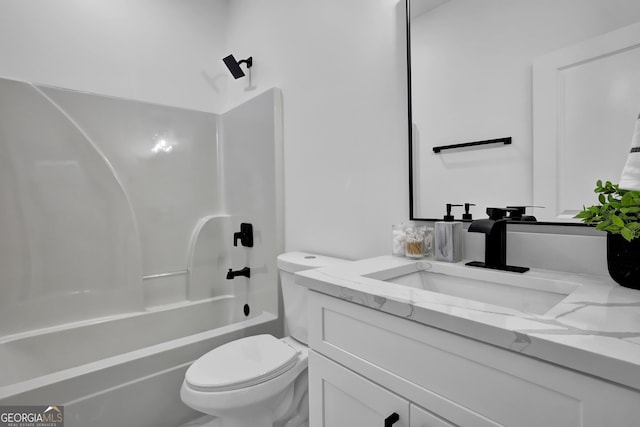 full bathroom featuring washtub / shower combination, vanity, and toilet