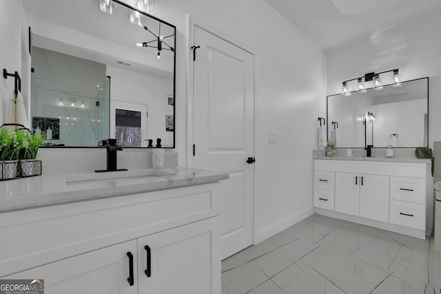 bathroom with vanity and a shower with door