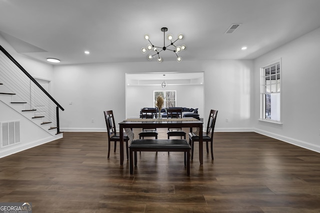 dining room with plenty of natural light, dark hardwood / wood-style flooring, and a chandelier