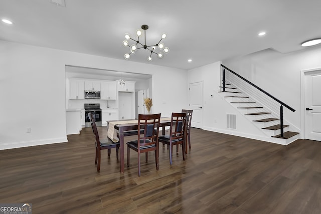 dining room featuring an inviting chandelier and dark hardwood / wood-style flooring