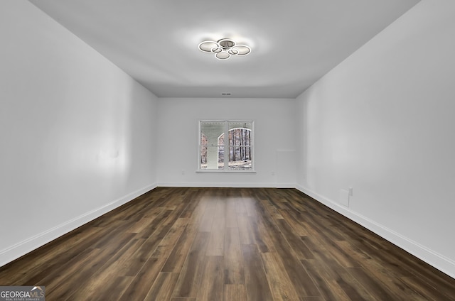 empty room featuring dark wood-type flooring