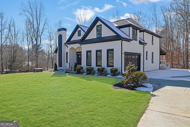 view of front of property featuring a garage and a front yard