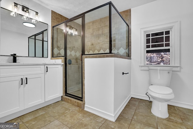 bathroom with a shower with door, vanity, a textured ceiling, tile patterned floors, and toilet