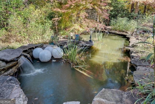 exterior details featuring a small pond