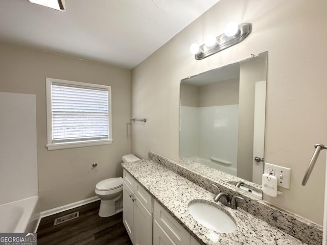 bathroom featuring vanity, toilet, and hardwood / wood-style floors