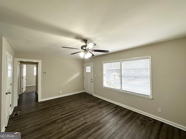 spare room featuring ceiling fan and dark wood-type flooring